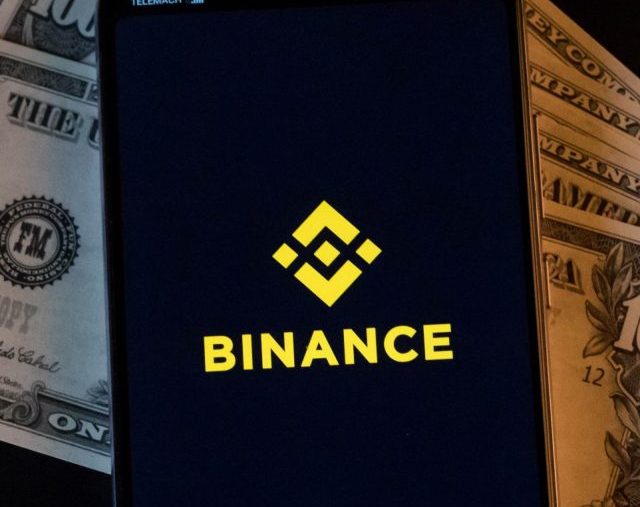 mobile-phone-and-binance-logo-on-dollars_cc-by-20