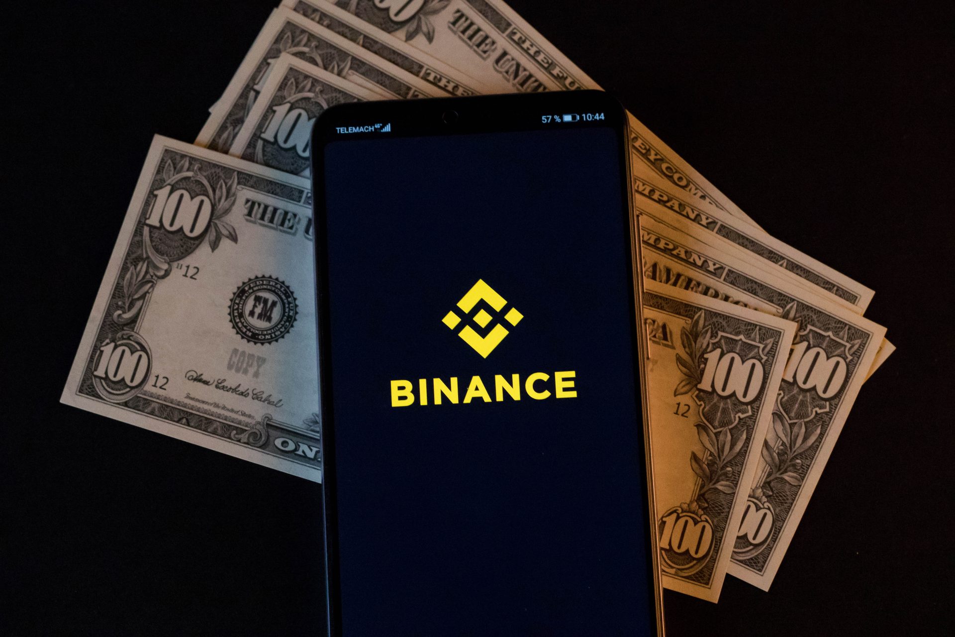 mobile-phone-and-binance-logo-on-dollars_cc-by-20