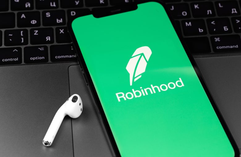 Robinhood mobile app on screen smartphone, iPhone with AirPods h