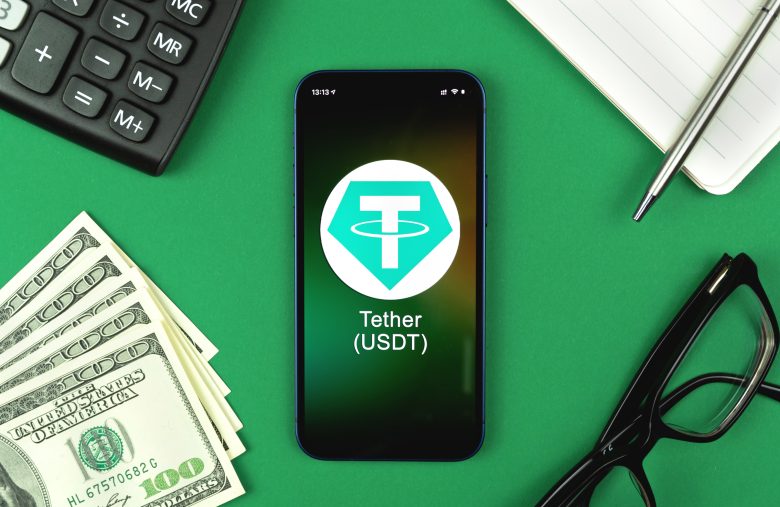 Tether USDT symbol. Trade with cryptocurrency, digital and virtual money, banking with mobile phone concept. Business workspace, table top view photo
