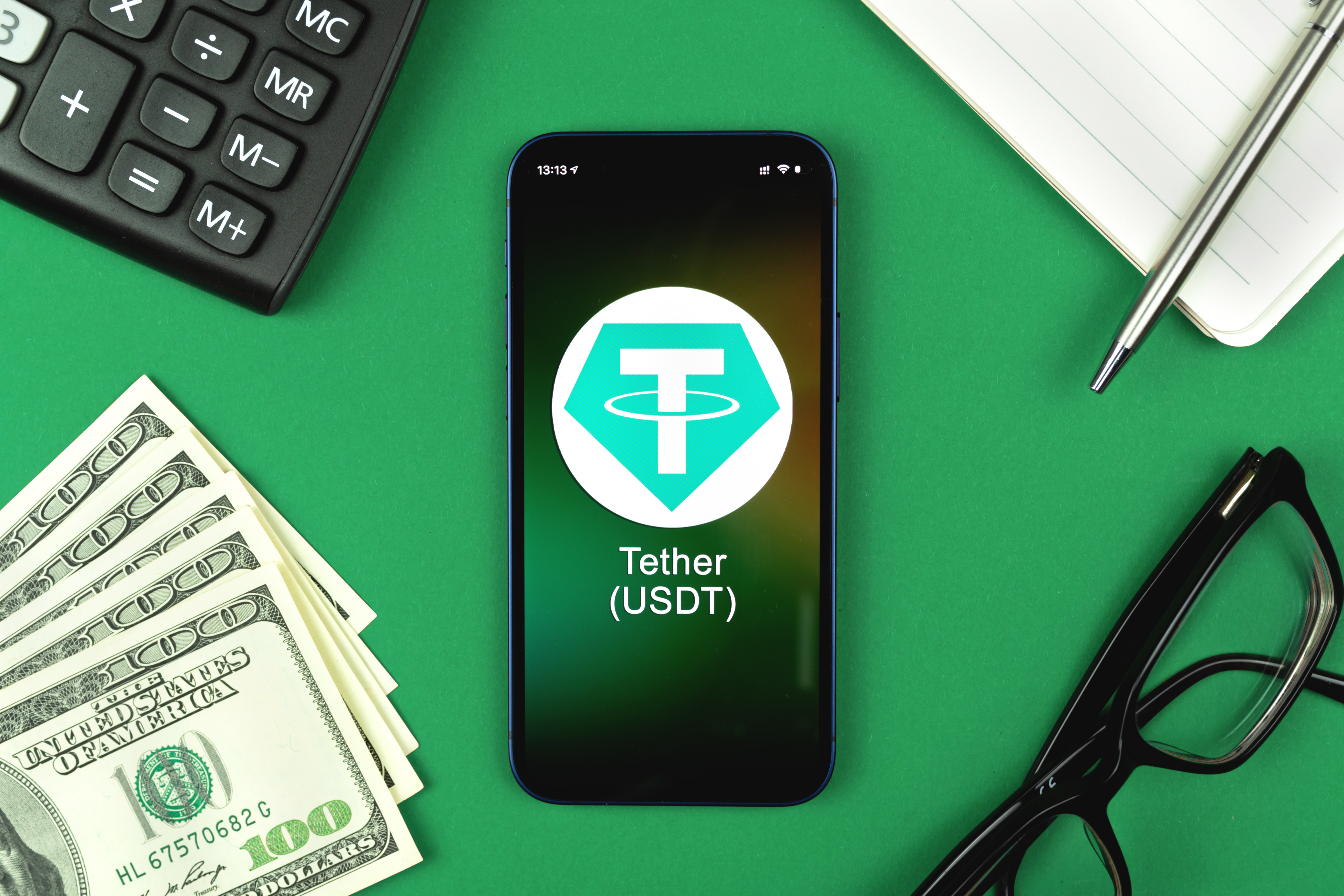 Tether USDT symbol. Trade with cryptocurrency, digital and virtual money, banking with mobile phone concept. Business workspace, table top view photo